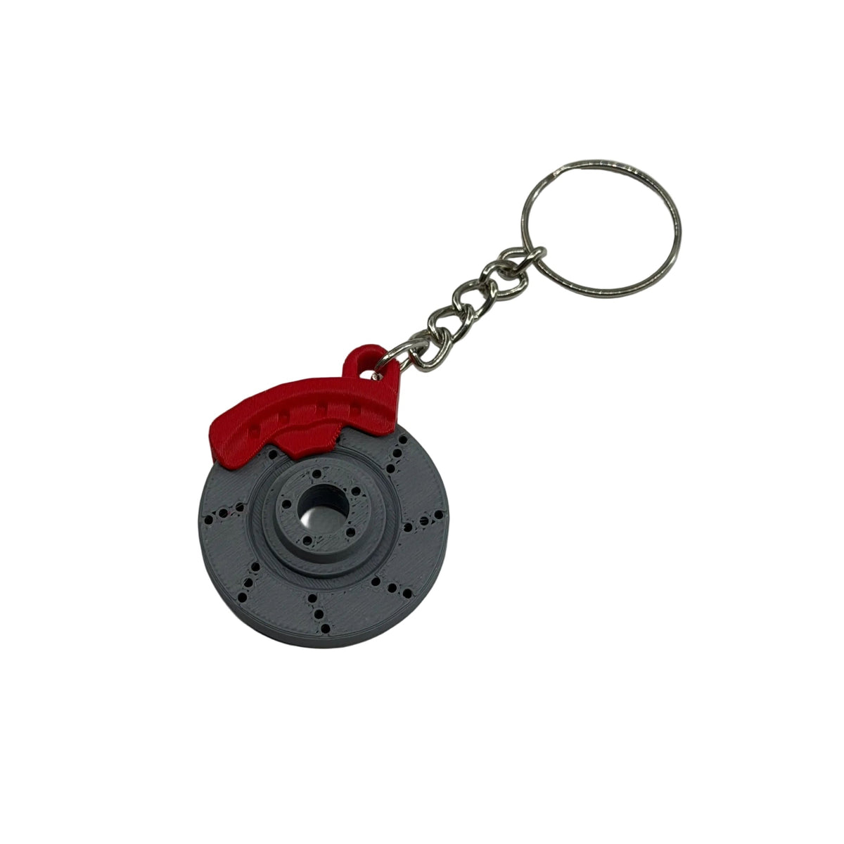 A novelty keychain shaped like a brake rotor with a red brake caliper and a silver metal split ring, shown on a plain white surface.